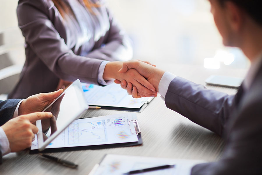 Business people shaking hands.